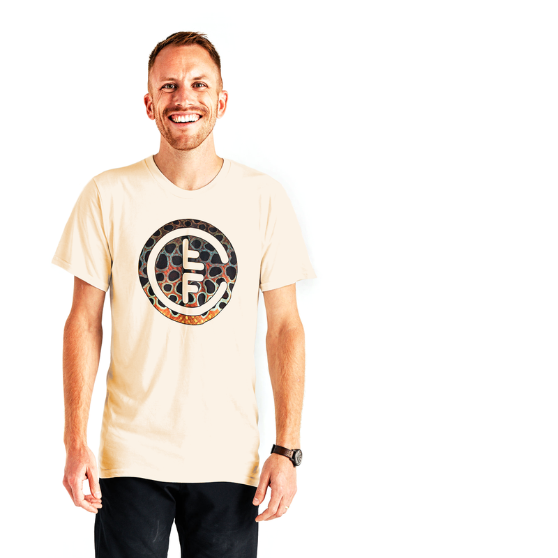 This Brown Trout T-Shirt features an artistically designed Fly Fishing Collaborative logo, here pictured on a man, front view.